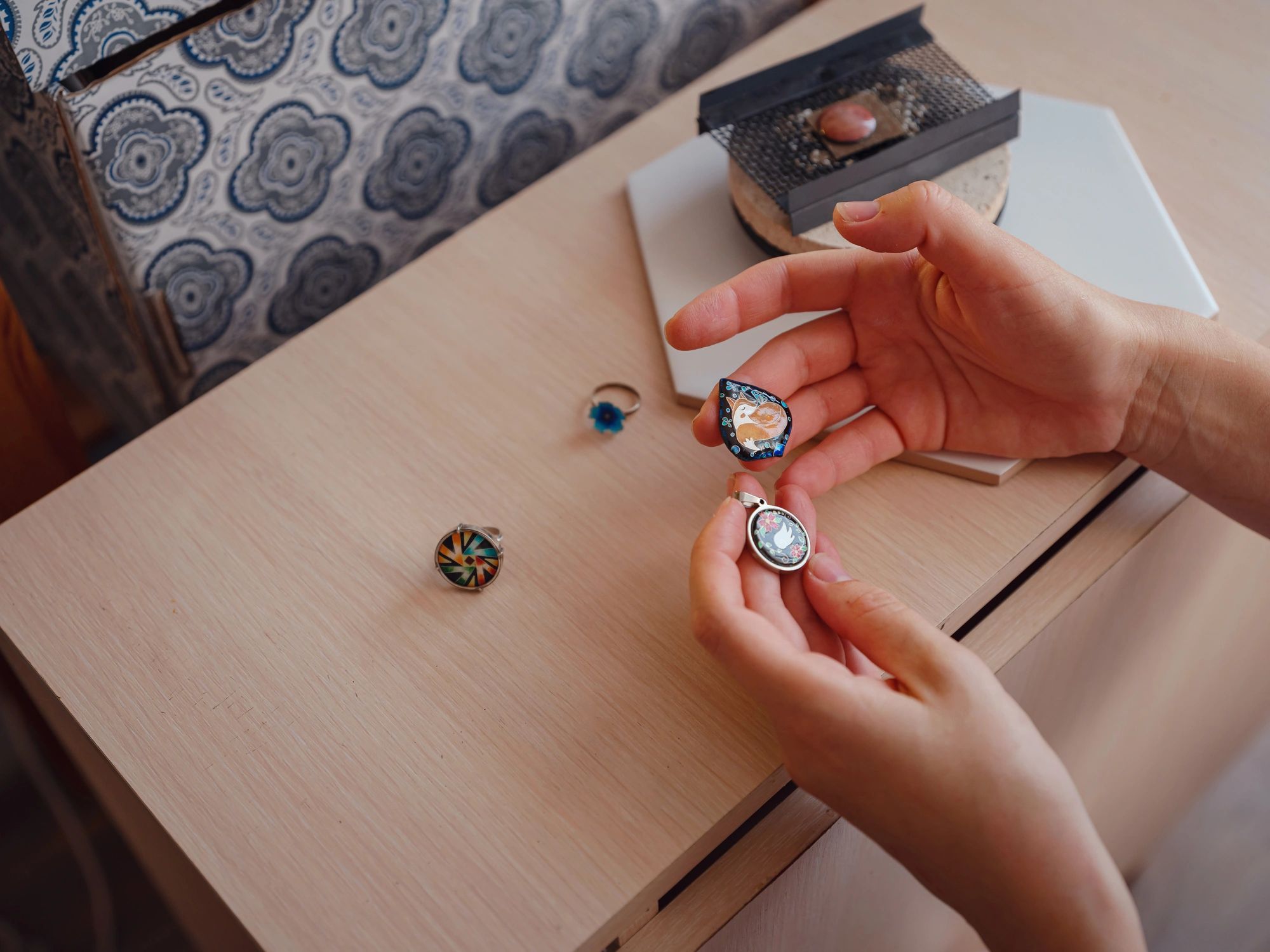 Jewelry designer working at a bench, assembling a piece by hand.